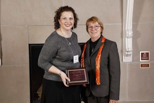 Lynette Horung and Beate Schmittmann, dean of the College of Liberal Arts and Sciences at awards ceremony, with plaque.