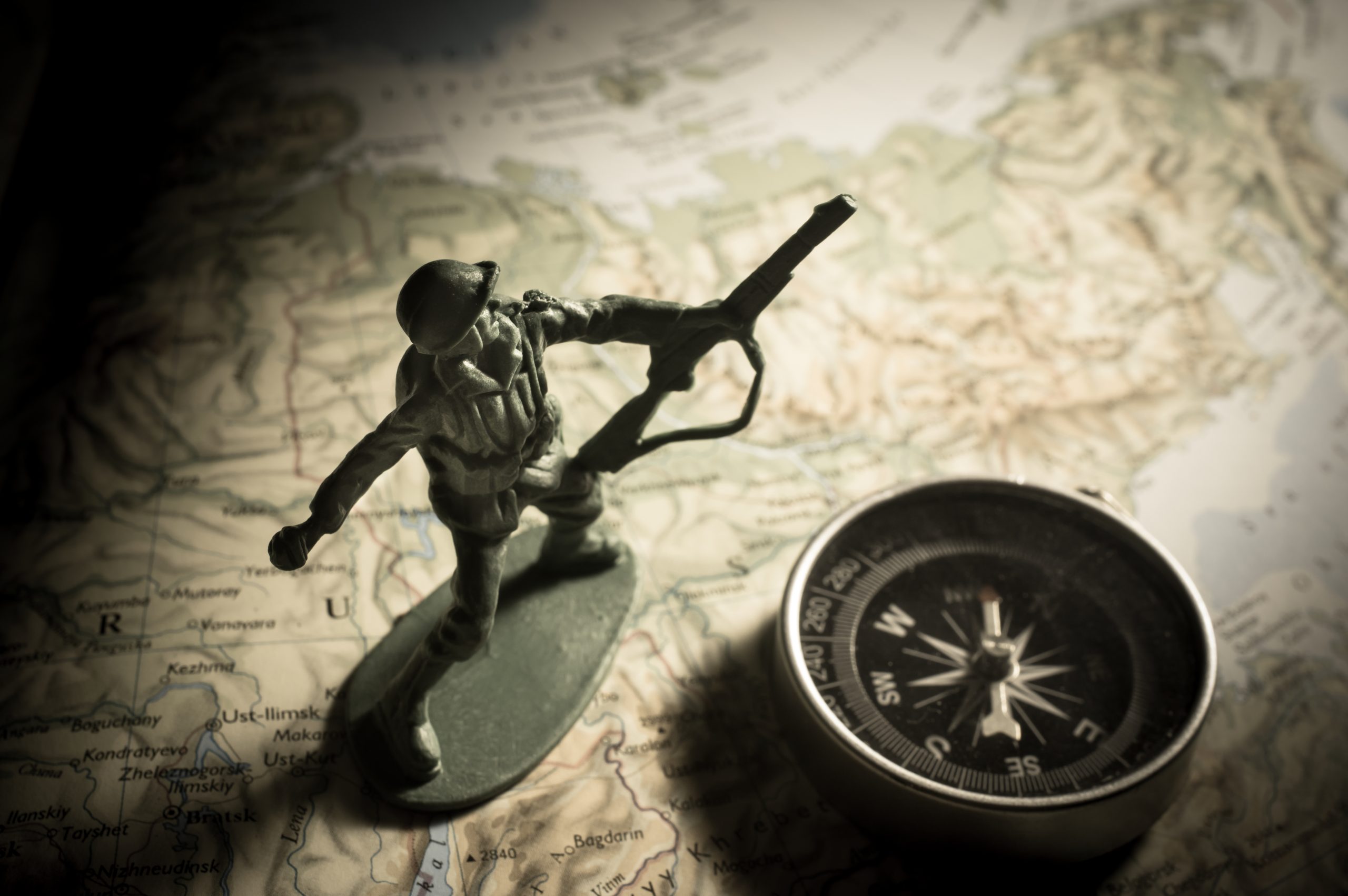 Toy soldier, compass, and a map